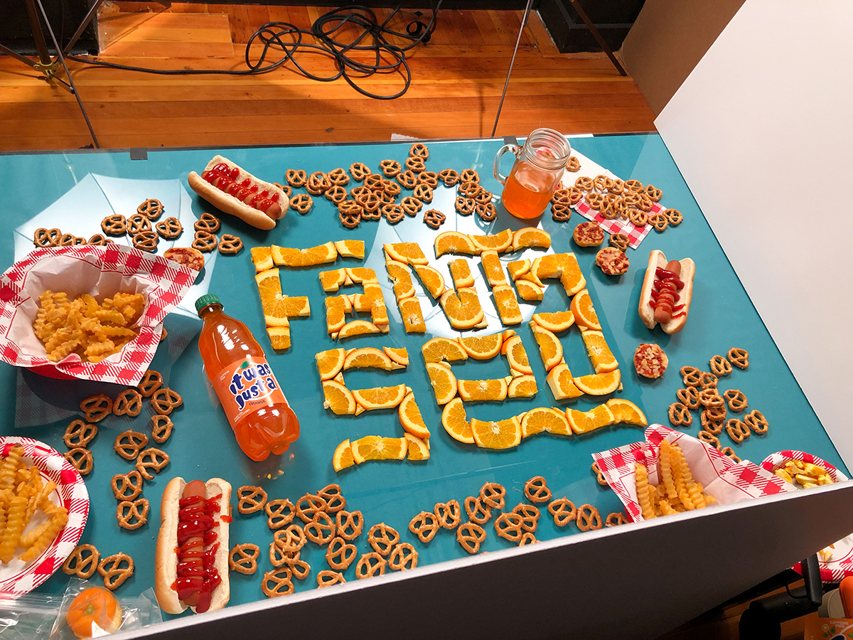 Behind-the-scenes of photo shoot for the previous image, showing the setup and detail of custom lettering.