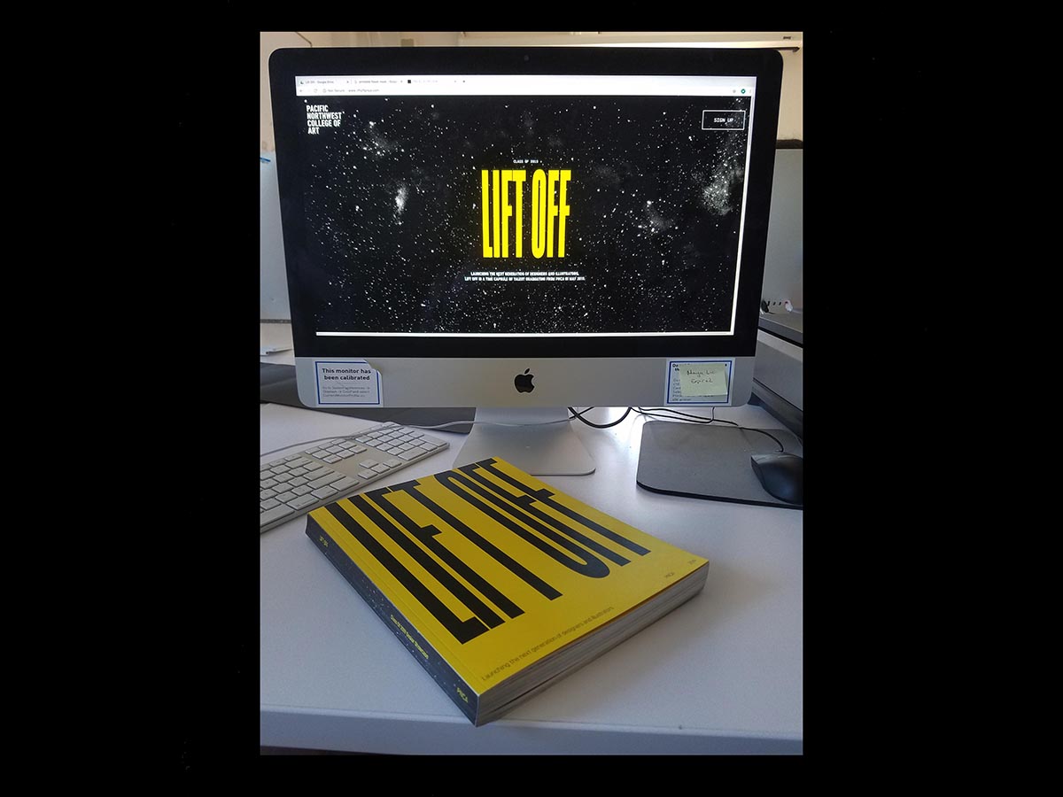 Photo of same book, on a table in front of a mac computer monitor, showing a website that reads 'LIFTOFF' over black and white abstract constellation design.